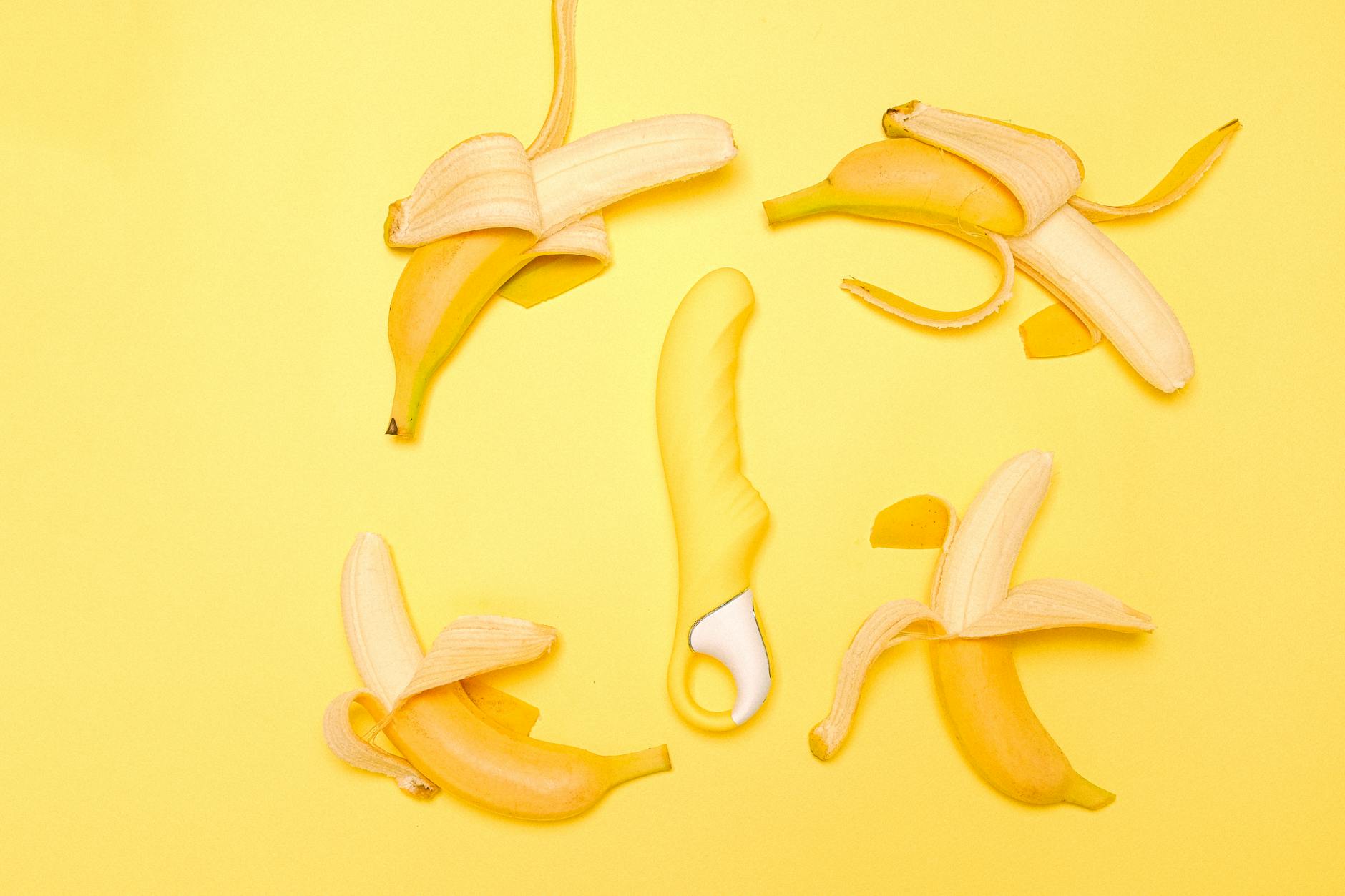 Yellow lemon-shaped vibrator on a bright yellow background, symbolizing fresh pleasure and restored sensation