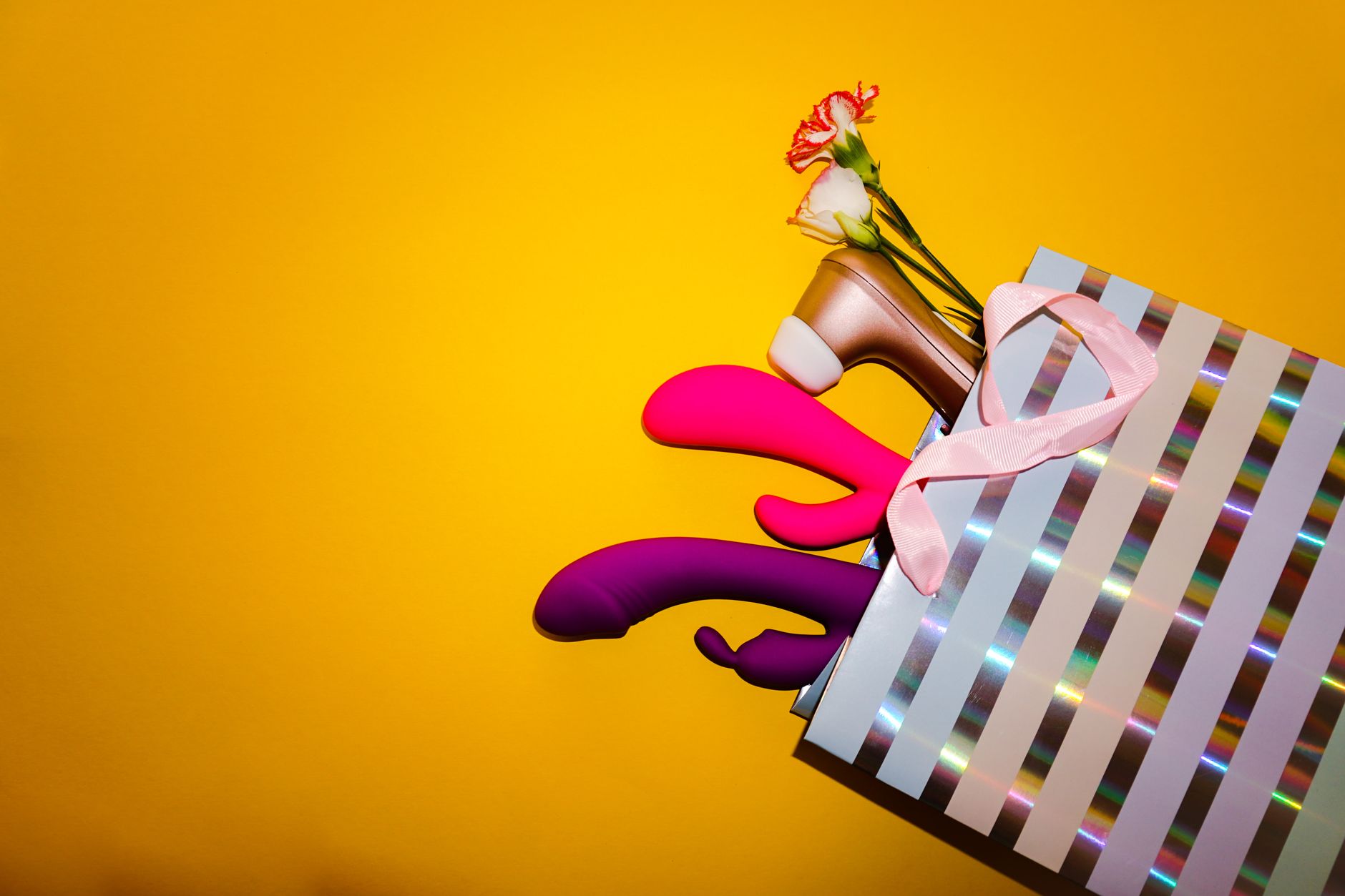 Yellow silicone vibrator with fresh fruit, symbolizing safe and natural pleasure after surgery